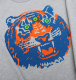 Close-up of gray crewneck sweatshirt with vibrant Detroit third-eye tiger graphic in blue, orange, and green