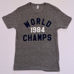 Vintage-style heather gray T-shirt featuring bold 1984 World Champs text in navy and white