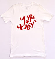 White t-shirt with large 'Life is Easy' text written in a red whimsical retro font