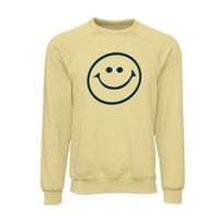 Light yellow crewneck sweatshirt featuring a simple, bold retro-style smiley face graphic in black ink on the front